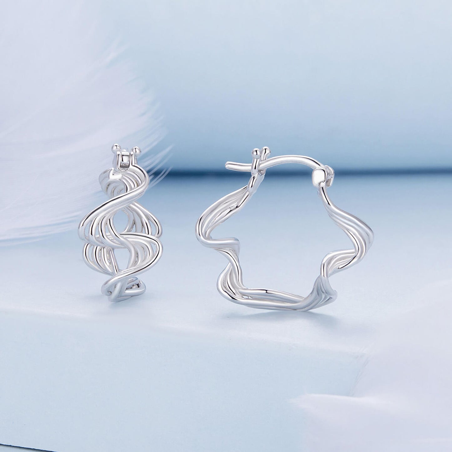 Wave Shaped Huggie Earrings in Sterling Silver front and side