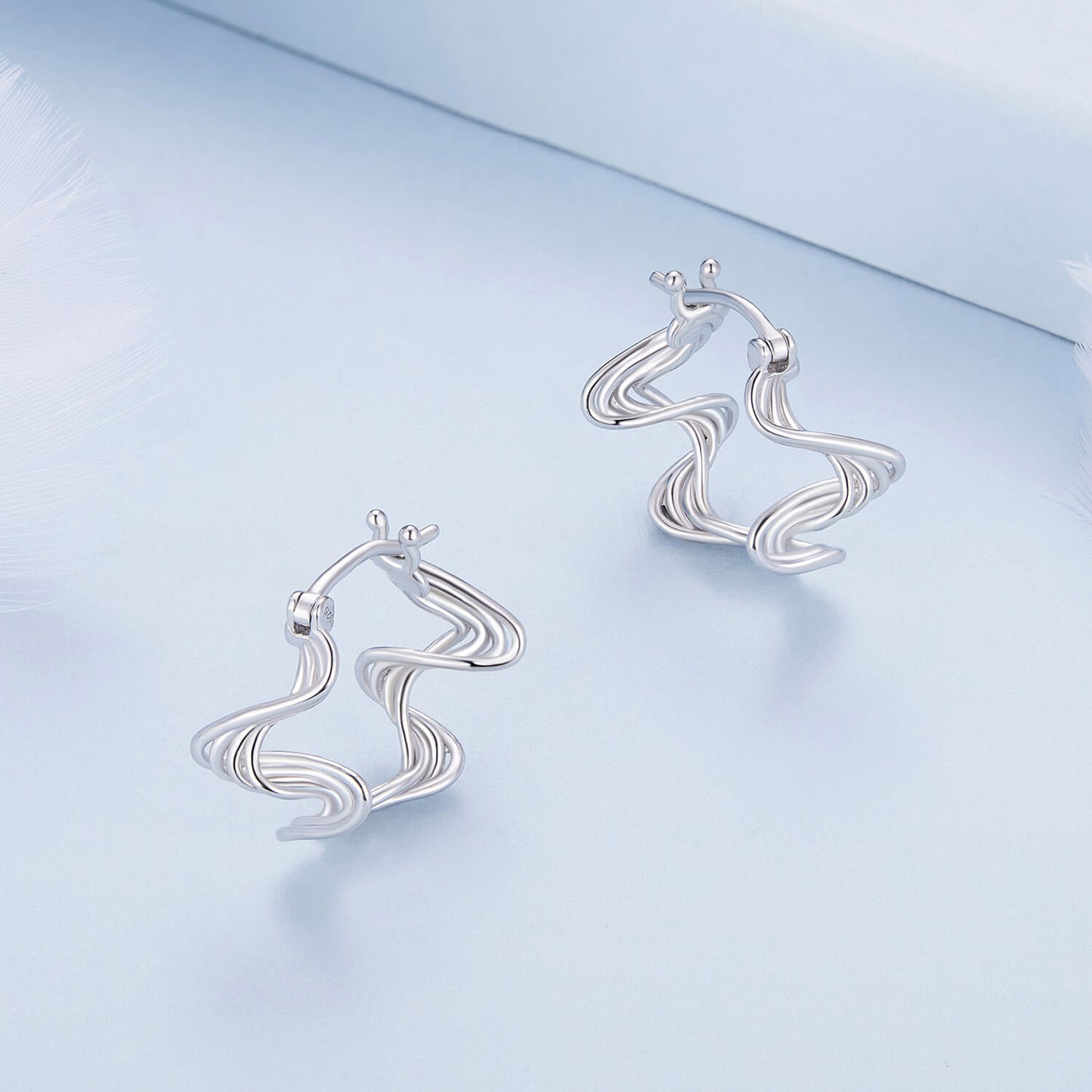 Wave Shaped Huggie Earrings in Sterling Silver 