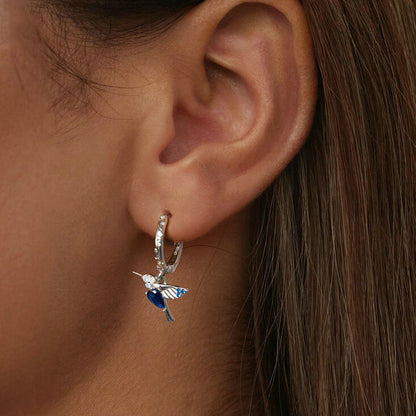 Elegant Blue Hummingbird Huggie Earrings in Sterling Silver - model wearing