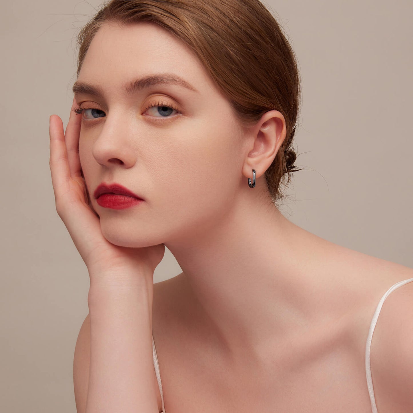 Black Ovate Huggie Earrings in Sterling Silver model