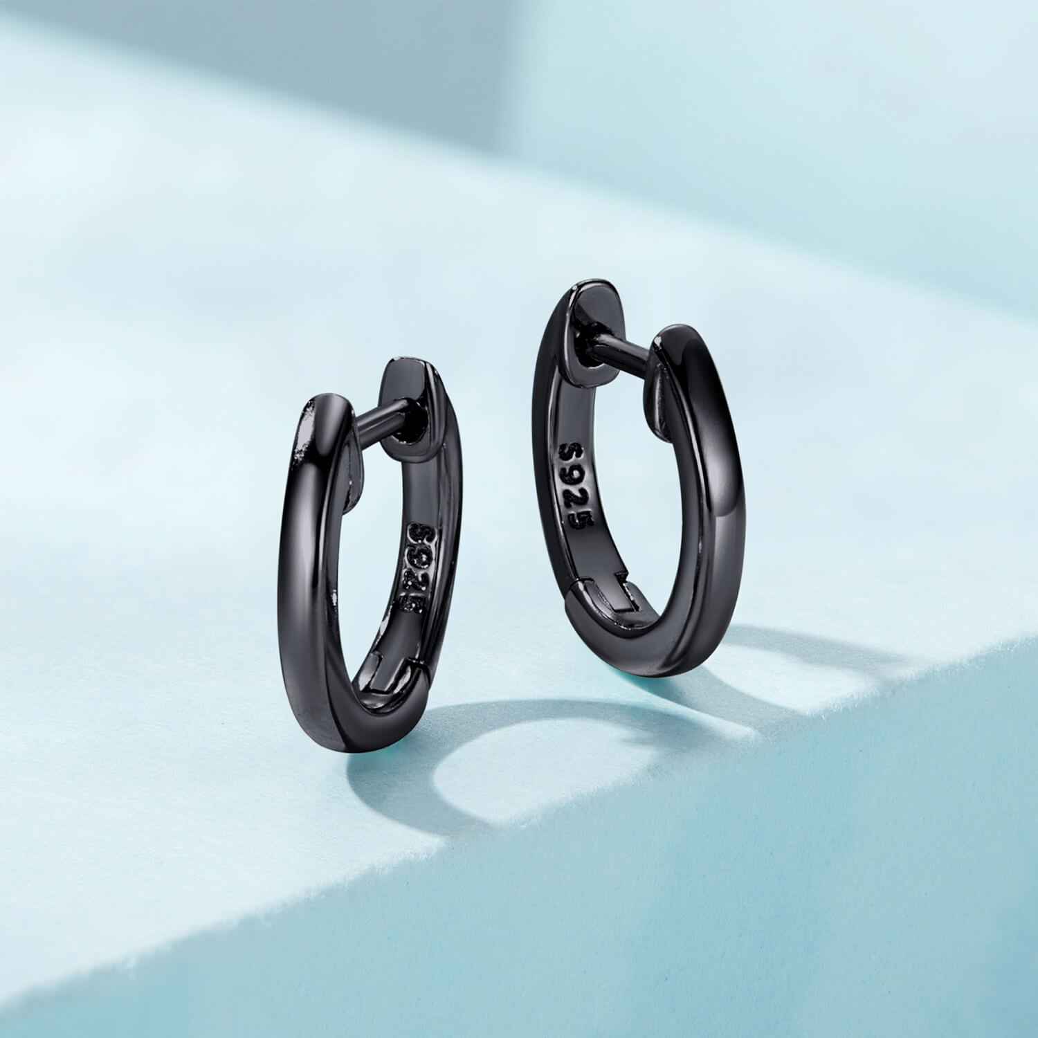 Small Black Round Huggie Earrings in Sterling Silver front